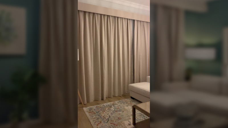 beige-and-white-motorized-curtains-in-living-room