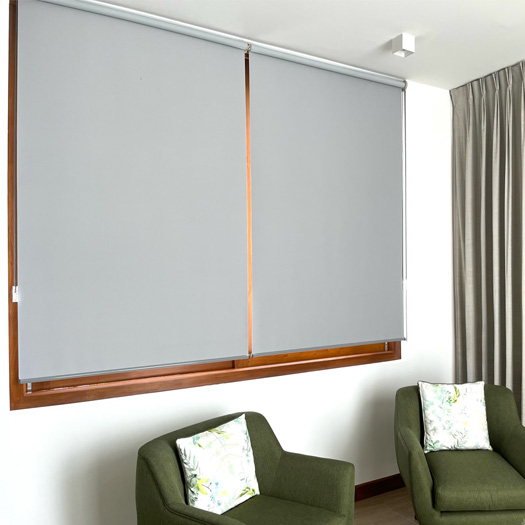 grey-roller-blinds-behind-green-chairs